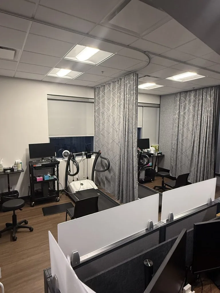 The clinic’s diagnostic testing area, with a treadmill and curtained assessment bays
