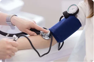 A blood pressure cuff and stethoscope being used to take a reading